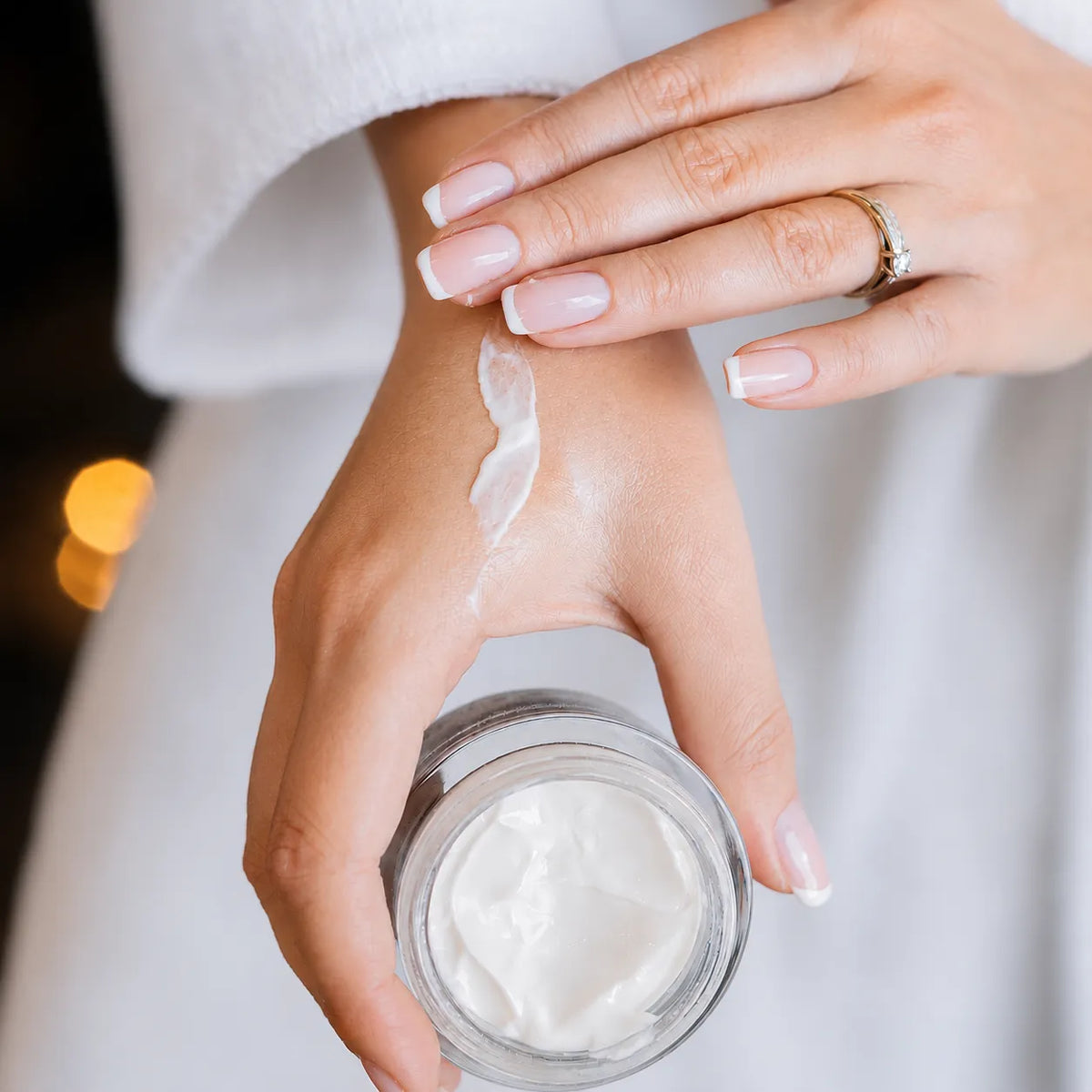Une main puise la crème dans le pot VICRIAN PARIS